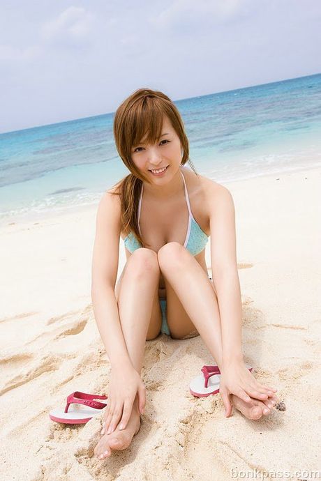 Pretty Japanese girl taking nude pictures at the beach