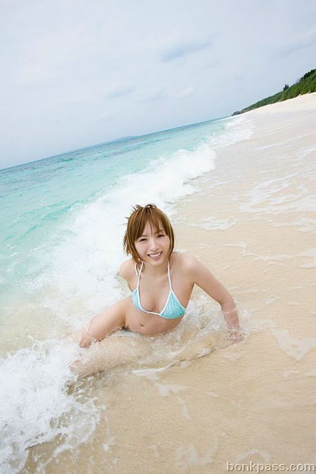 Pretty Japanese girl taking nude pictures at the beach