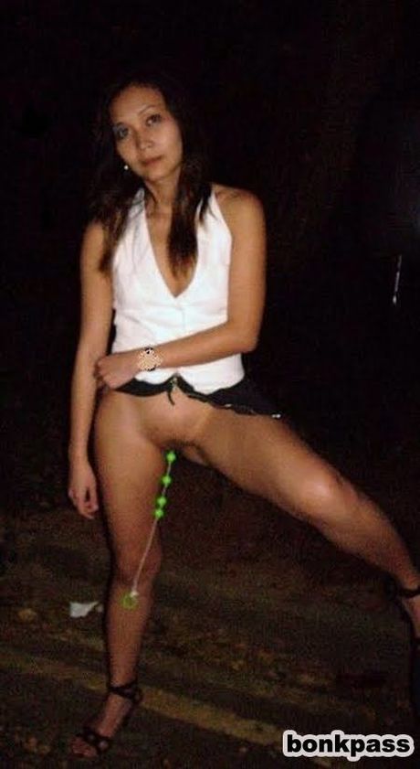 Horny Thai girl flashing with sex toy at night