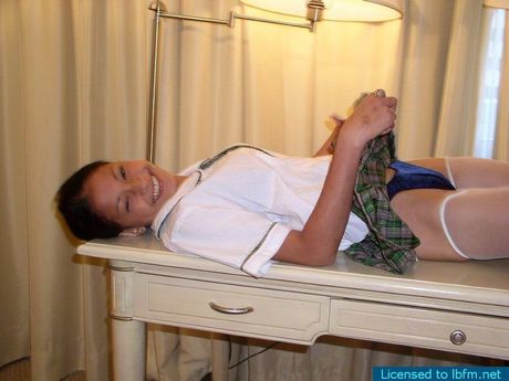 Amateur Asian schoolgirl strips and shows her shaved pussy up close