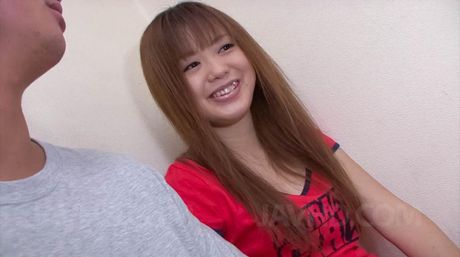 Noriko Kago Asian doll in red t-shirt takes care of phallus head