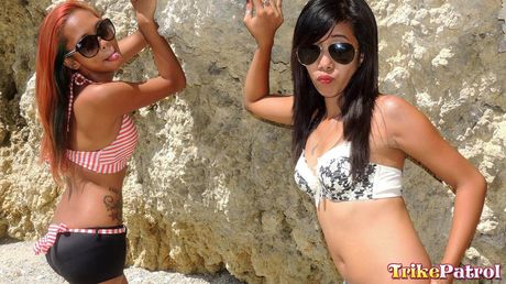 Asian teens Shanelle and Bubbles flaunt their big bootyes and tits outdoors