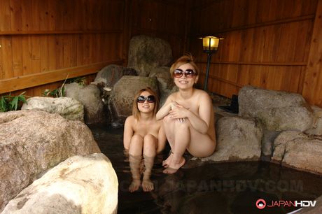 Attractive Japanese sluts strip naked and suck on a thick hard cock.