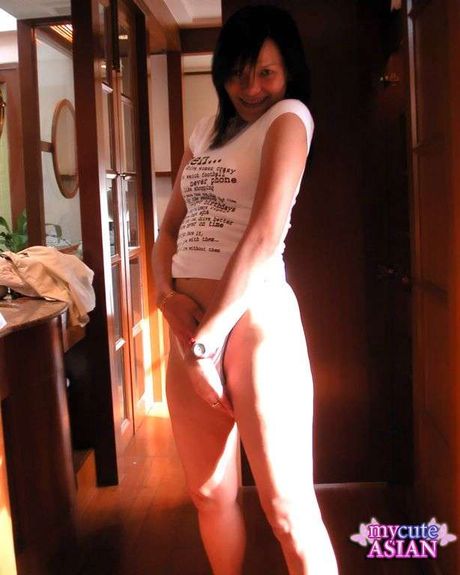 Amateur Asian teenager strips and toys her pussy with a dildo