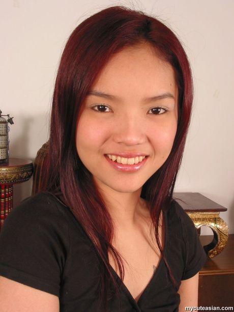 Amateur Asian girl with a tiny tits strips and shows her hairy cunt