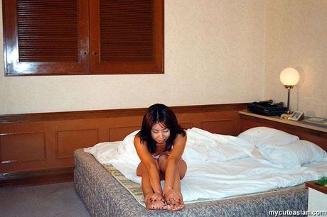 Stunning Asian wife with small tits and a sexy booty strips and reveals her naked form