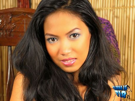 Amateur Asian girl strips and toys her hairy pussy with a dildo