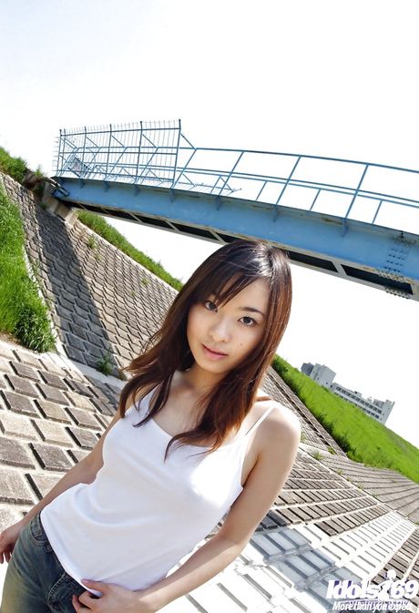 Shapely japanese teen Hikaru Koto in jeans shows big hooters and sexy butt outside